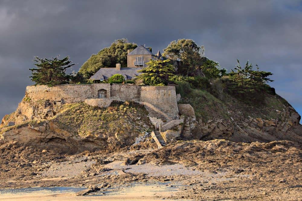 Fort du Guesclin: The Storm’s Embrace 1 Moody and dramatic stormy sky above Fort du Guesclin. Dark clouds over the historic French tidal island castle. Atmospheric coastal scenery from the Emerald Coast in Brittany.